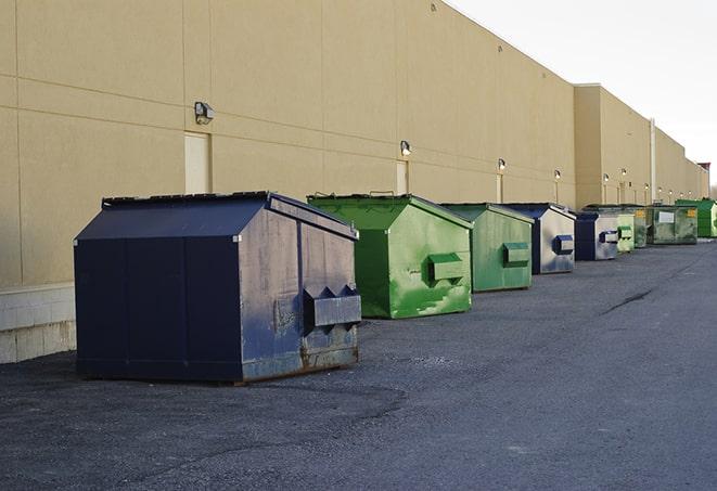 a row of yellow and blue dumpsters at a construction site in Dornsife, PA